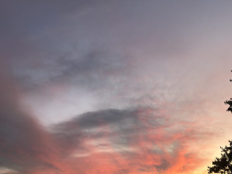 A sky filled with lots of clouds at sunset.